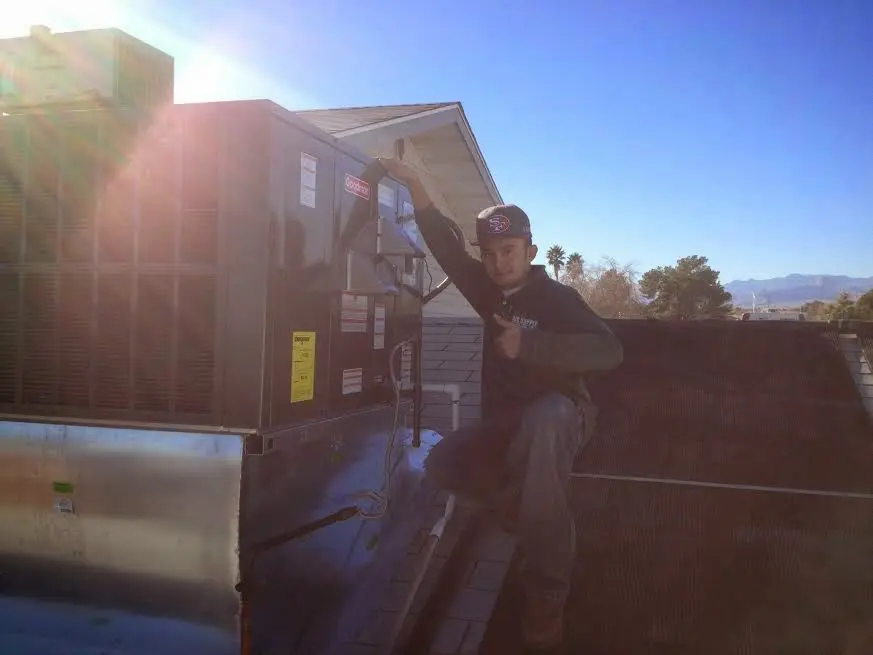 HVAC technician performing AC Tune-Up on a rooftop unit in Swatara